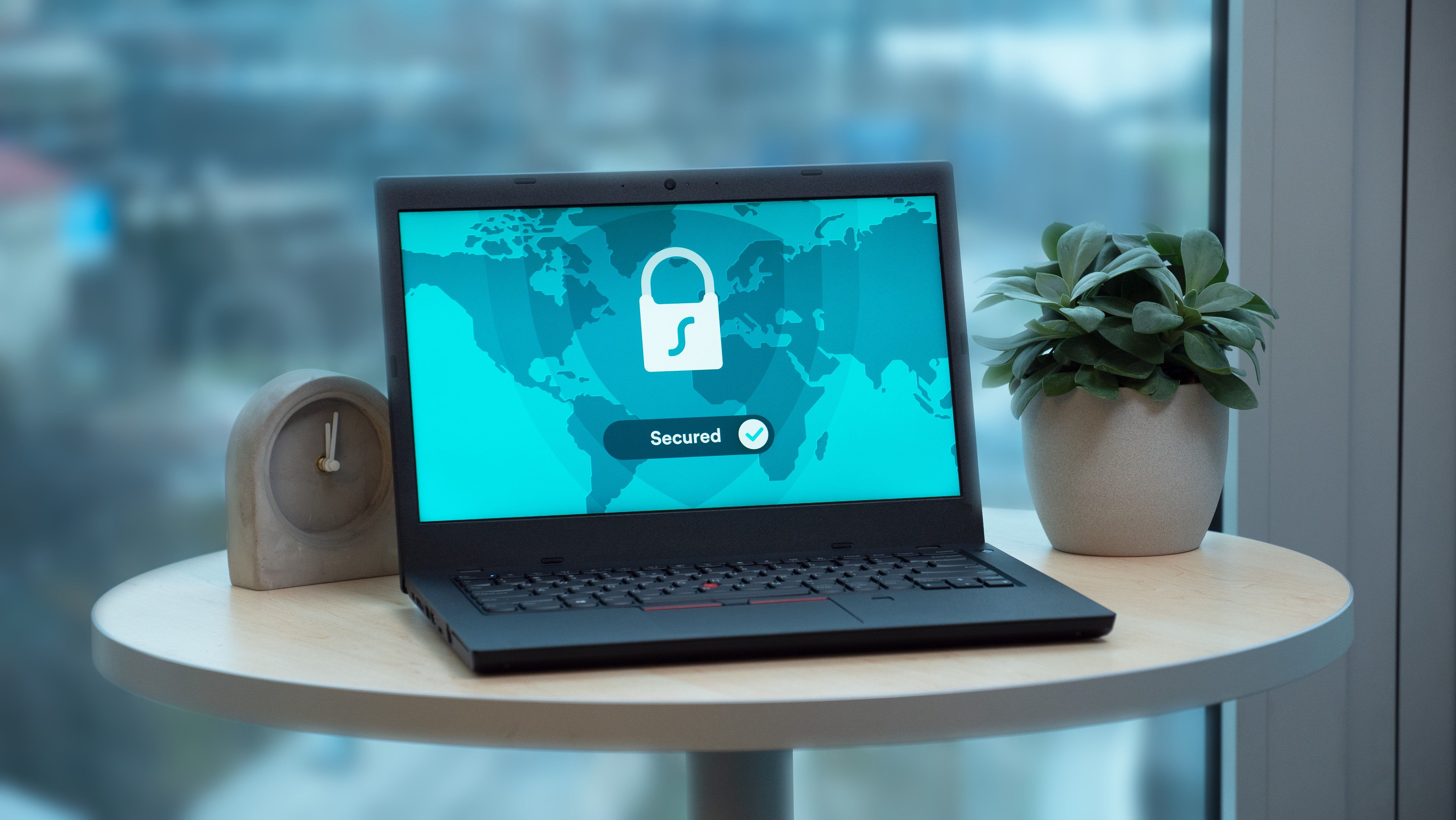 Laptop displaying a secure-access symbol in a modern workspace