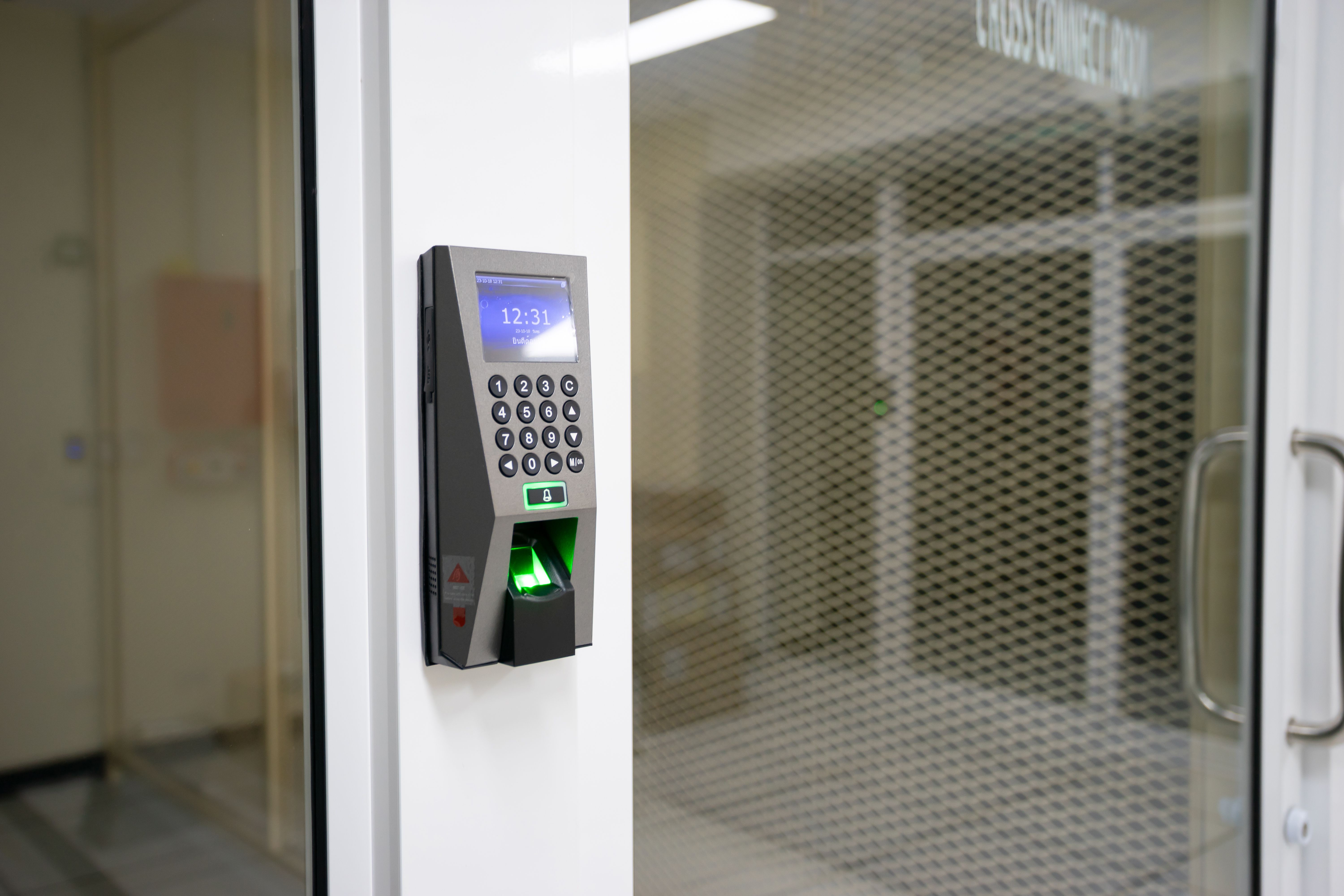 Fingerprint access-control panel beside a secure office doorway